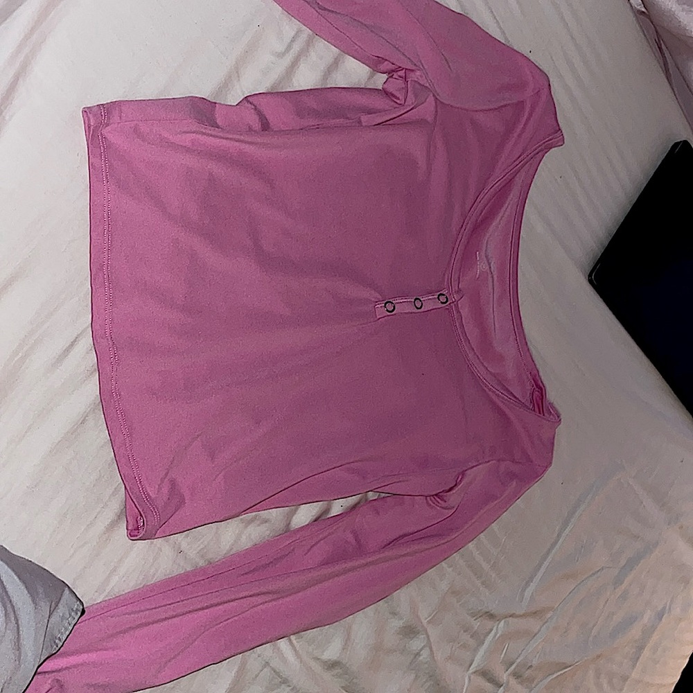 Pink mid buttons long sleeve shirt, it’s light pink specifically.